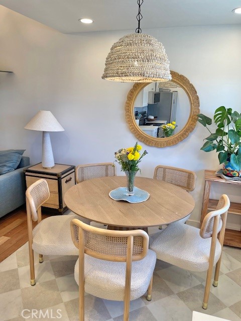 3080 Lincoln Street, Unit 17 Carlsbad, CA 92008 - Photo 14 of 26 a dining room with furniture and a chandelier
