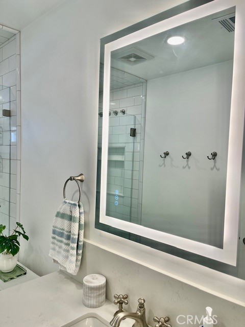 3080 Lincoln Street, Unit 17 Carlsbad, CA 92008 - Photo 17 of 26 a bathroom with a granite countertop sink and a mirror