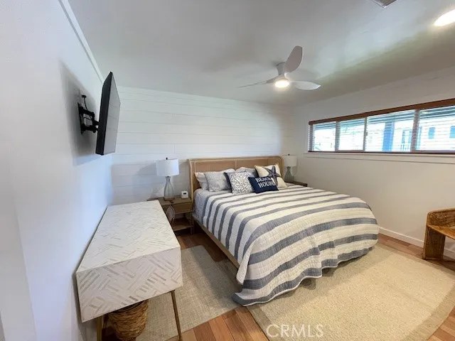 a bedroom with furniture and wooden floor