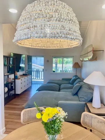 a living room with furniture and a chandelier