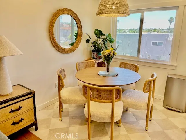 a dining room with furniture and a window