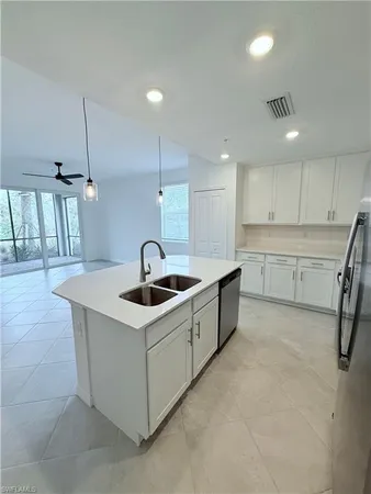 a kitchen that has a sink a stove and a table with chairs