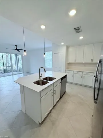 a kitchen that has a sink a stove and a table with chairs