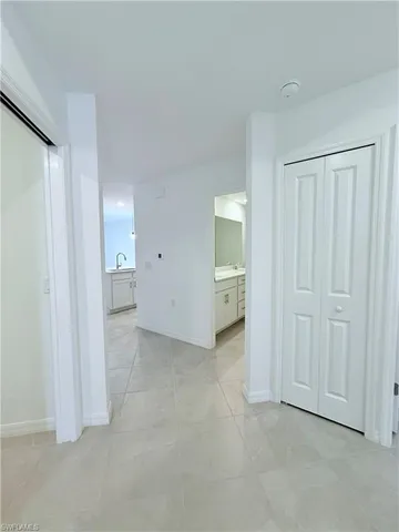 an empty room with a bathroom and a sink