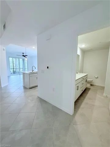 a view of a room with white cabinets