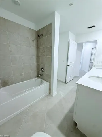 a spacious bathroom with a bathtub and a shower