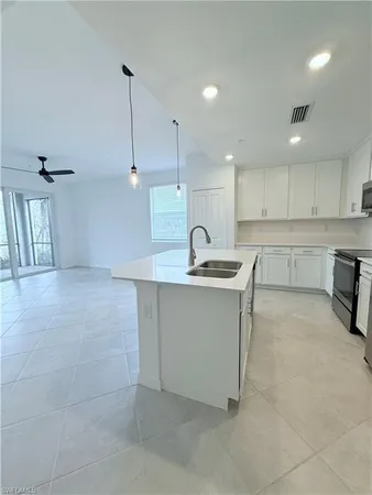 a kitchen with a sink cabinets and window