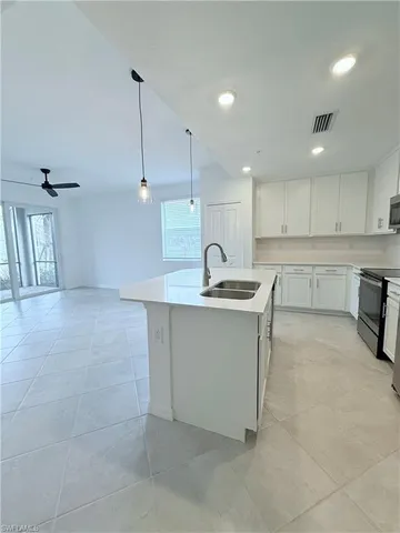 a kitchen with a sink cabinets and window