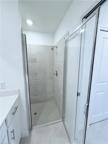 a bathroom with a shower and a sink