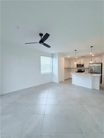 a view of a kitchen with a sink and a refrigerator