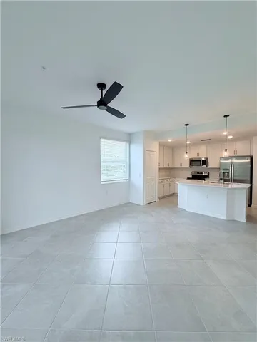 a view of a kitchen with a sink and a refrigerator