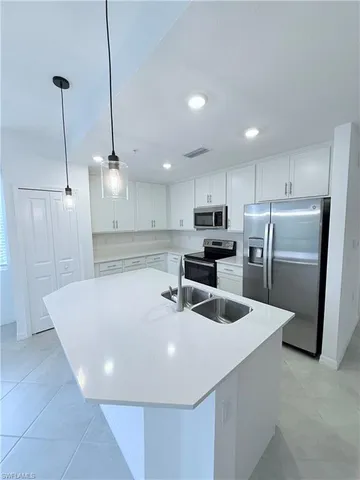a view of a kitchen with a sink and cabinets