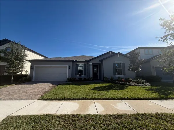 a front view of a house with a yard and garage