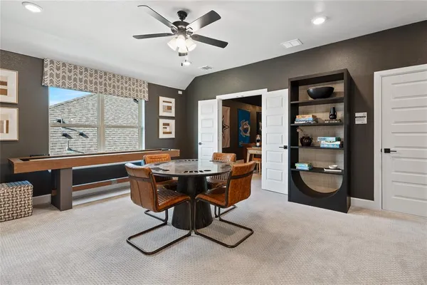 a bedroom with a bed two lamps and a window