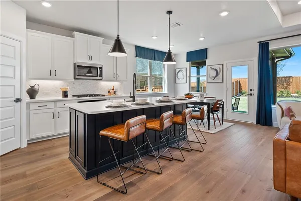 a bathroom with a tub a sink and mirror
