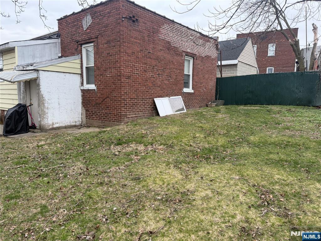 92 Naples Place Garfield, NJ 07026 - Photo 3 of 3 front view of a house with a yard