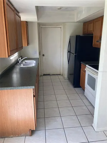 a kitchen with stainless steel appliances granite countertop a refrigerator and a stove