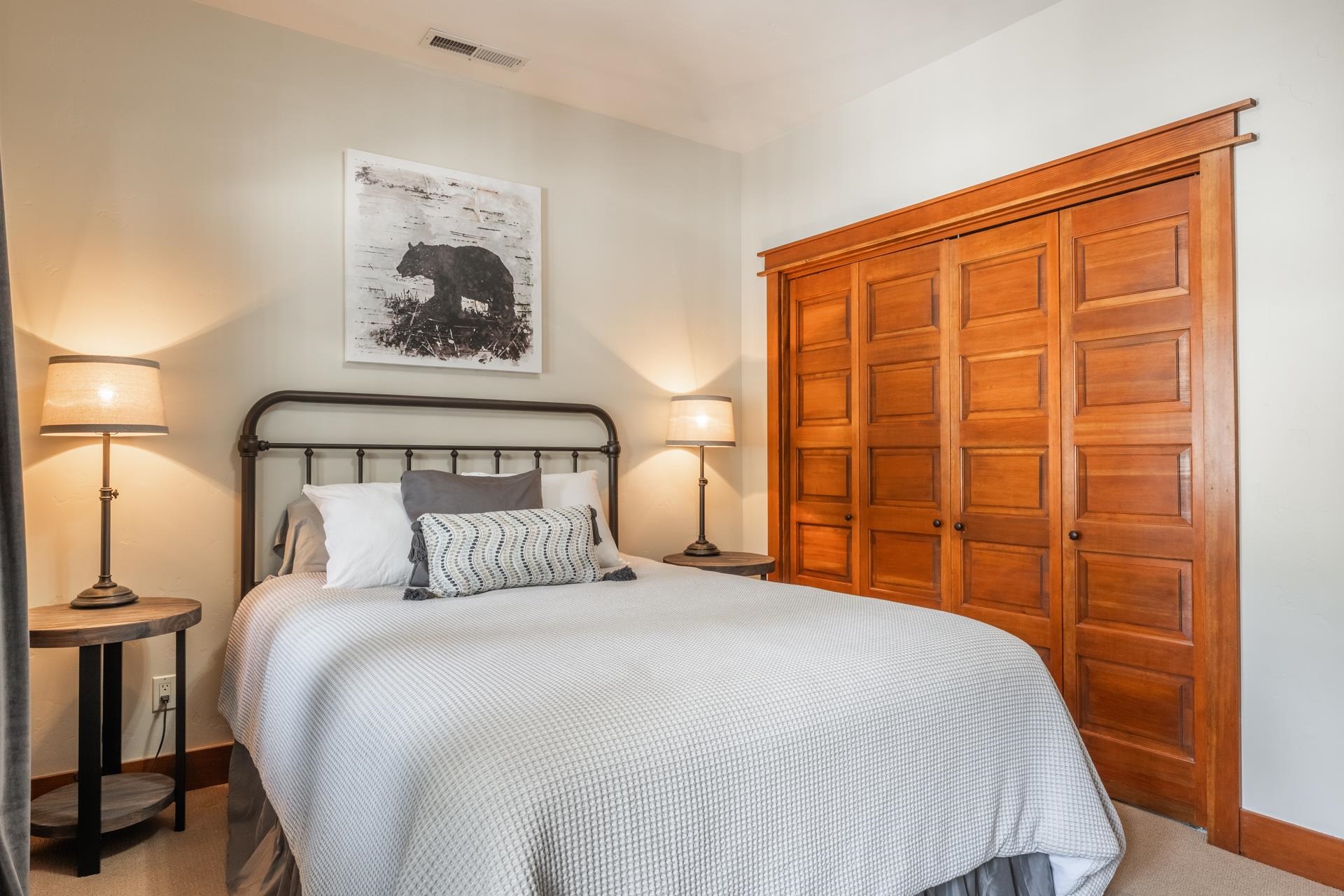 125 Davison Road, Unit 1 Mammoth Lakes, CA 93546 - Photo 41 of 46 a bedroom with a large bed and a painting on the wall