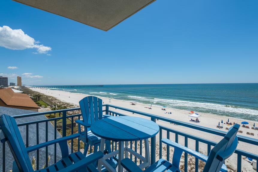 16701 Front Beach Road, Unit 401 Panama City Beach, FL 32413 - Photo 12 of 22 a view of a swimming pool with a table and chairs