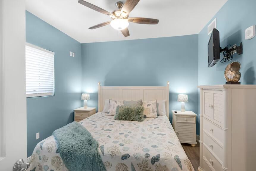 16701 Front Beach Road, Unit 401 Panama City Beach, FL 32413 - Photo 21 of 22 a bedroom with a bed and a chandelier