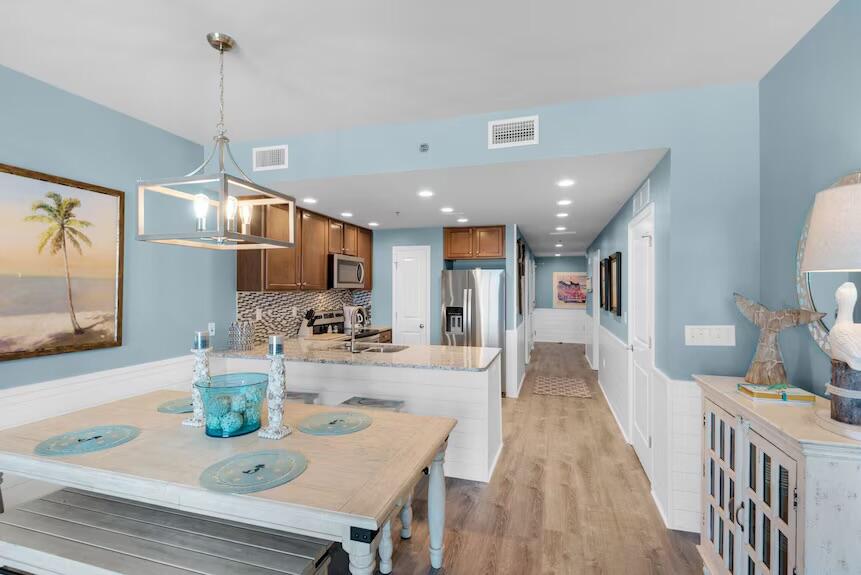 16701 Front Beach Road, Unit 401 Panama City Beach, FL 32413 - Photo 6 of 22 a dining room with stainless steel appliances furniture a window and kitchen view