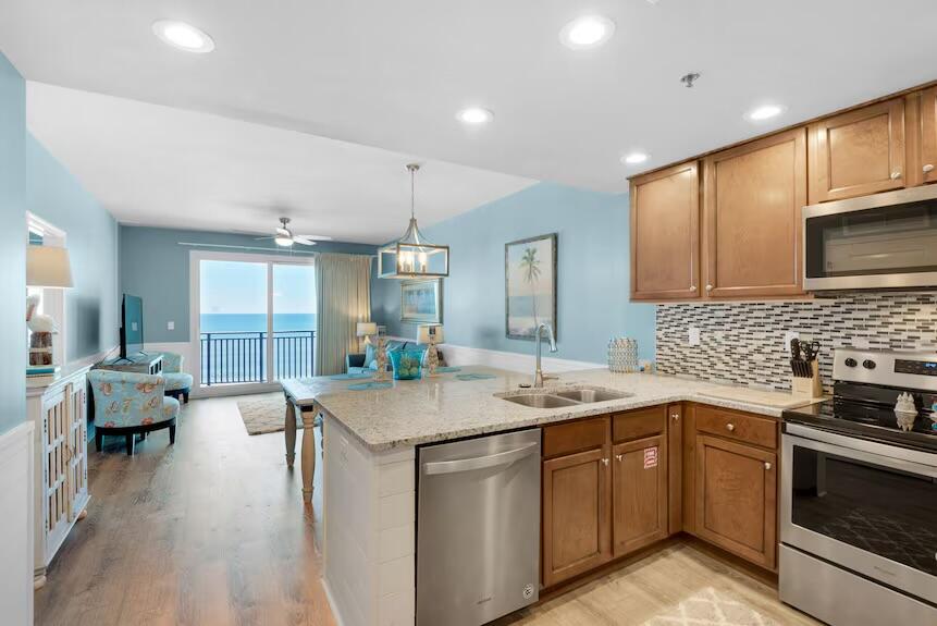 16701 Front Beach Road, Unit 401 Panama City Beach, FL 32413 - Photo 9 of 22 a kitchen with a sink stove and cabinets