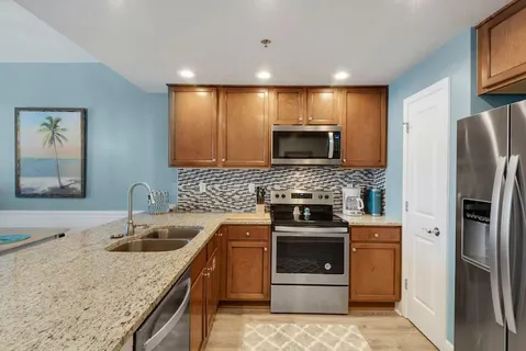 a kitchen with a sink stove and refrigerator