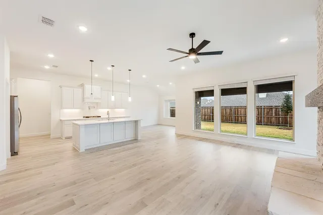 a view of large kitchen with stainless steel appliances refrigerator oven and cabinets