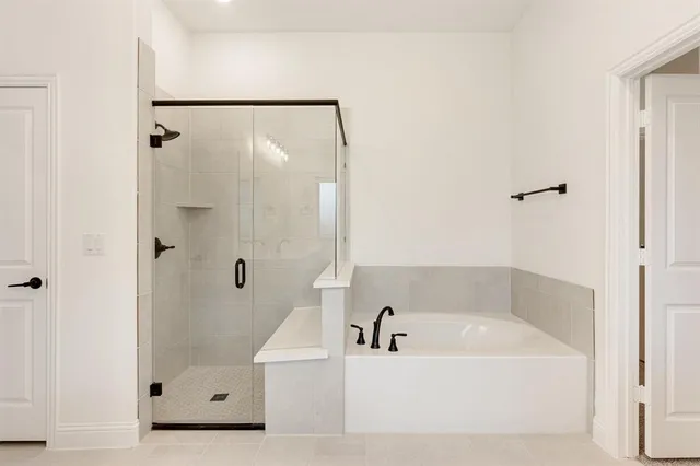 a bathroom with a bathtub and shower