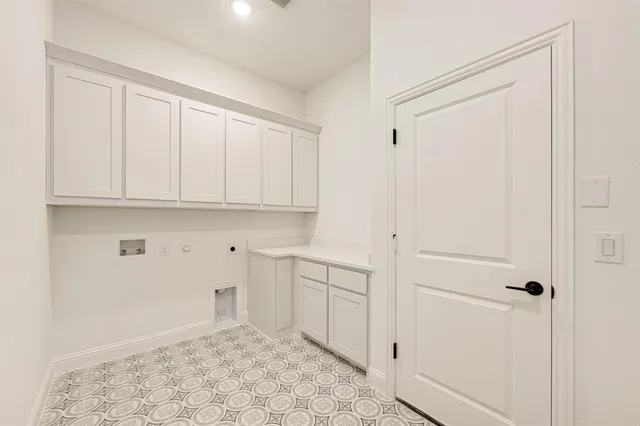 a view of a kitchen with white cabinets