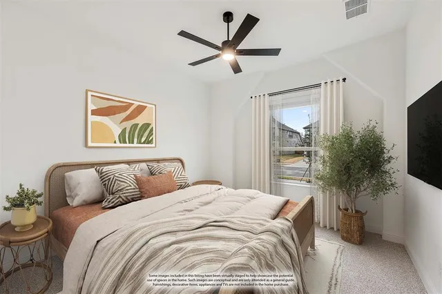 a bedroom with a bed and a potted plant