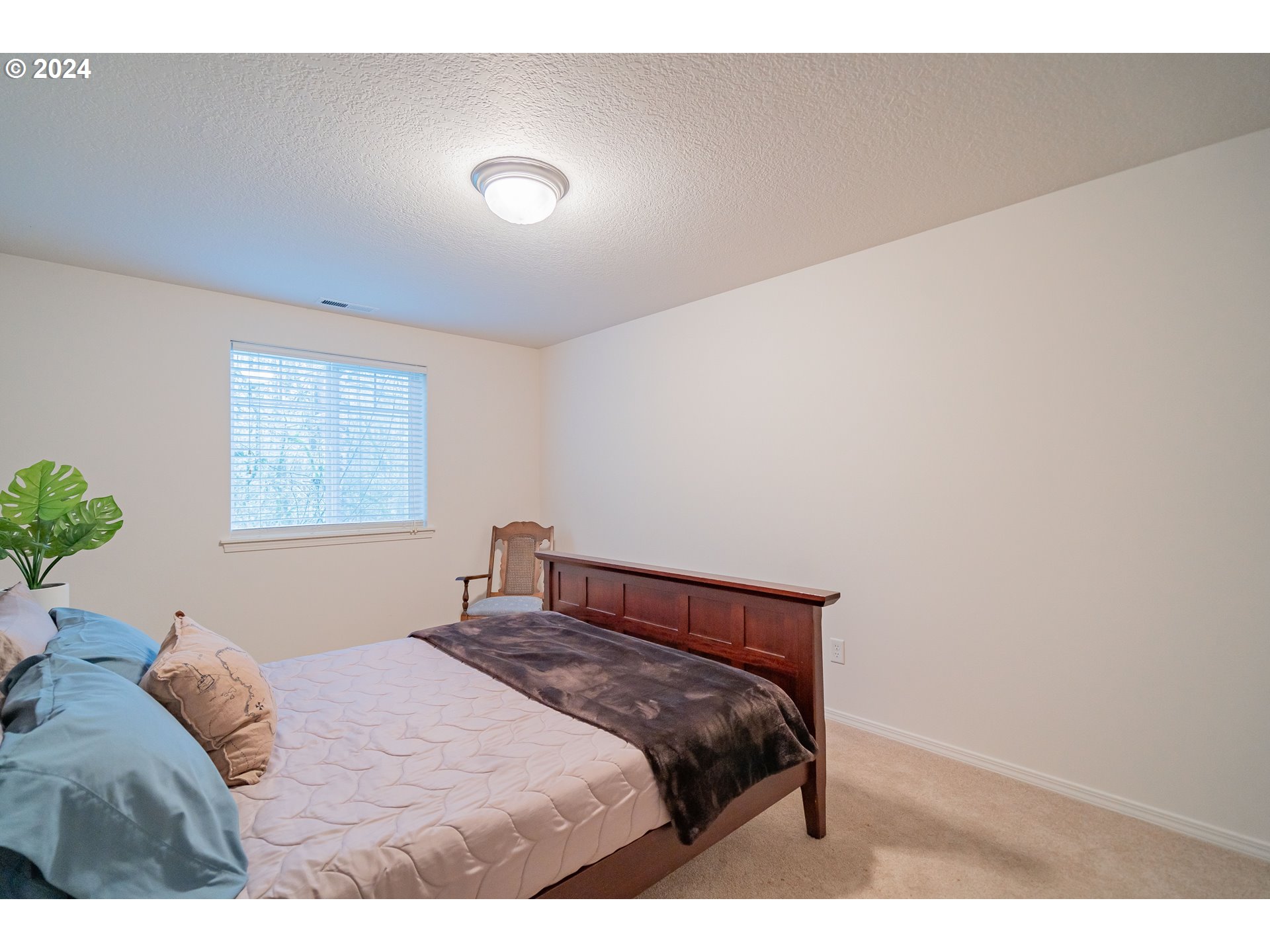 1420 Southeast 5th Way Battle Ground, WA 98604 - Photo 22 of 32 a bedroom with a bed and a painting on the wall