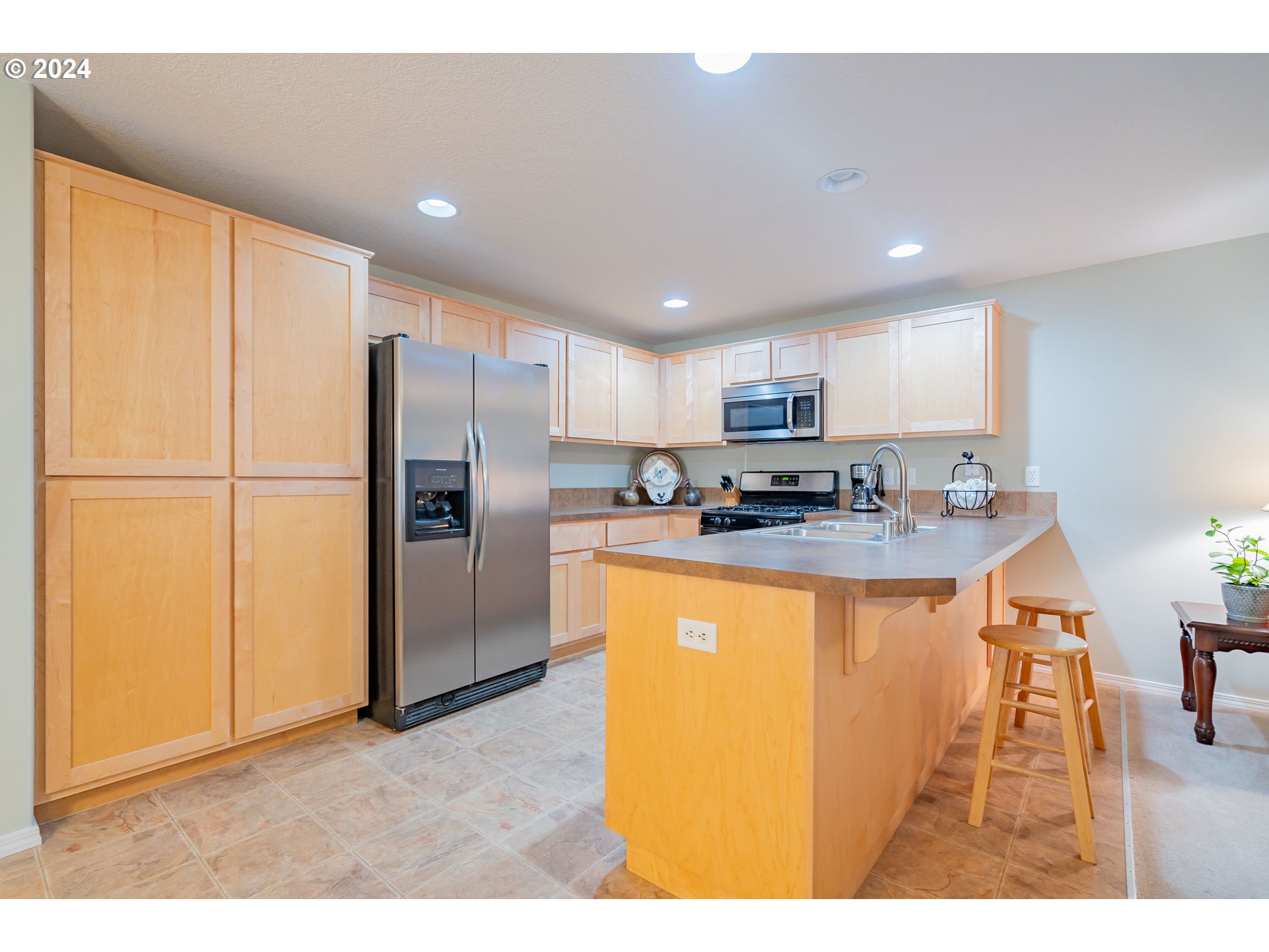 1420 Southeast 5th Way Battle Ground, WA 98604 - Photo 5 of 32 a kitchen with stainless steel appliances granite countertop a refrigerator a sink a stove a microwave and island