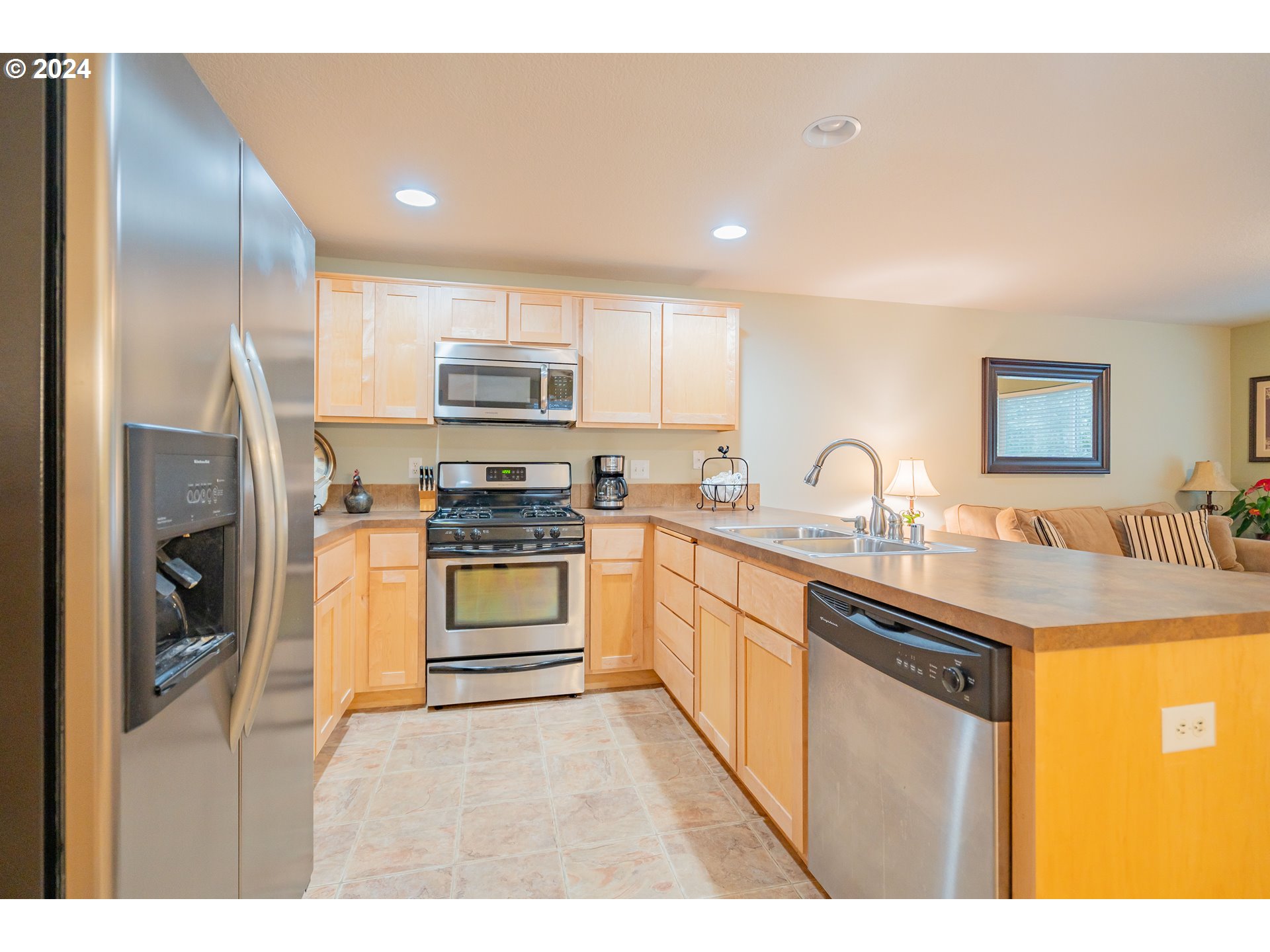 1420 Southeast 5th Way Battle Ground, WA 98604 - Photo 6 of 32 a kitchen with stainless steel appliances granite countertop a stove a sink and a refrigerator