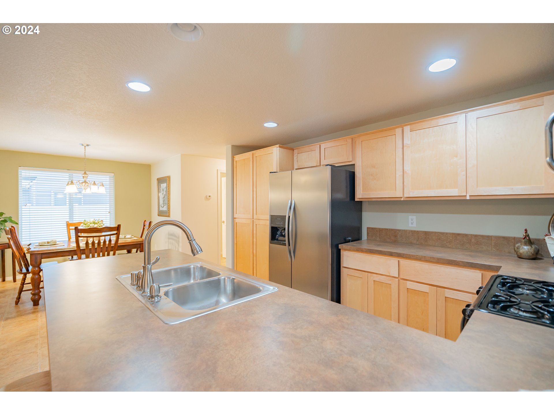 1420 Southeast 5th Way Battle Ground, WA 98604 - Photo 8 of 32 a kitchen with kitchen island a sink appliances and cabinets