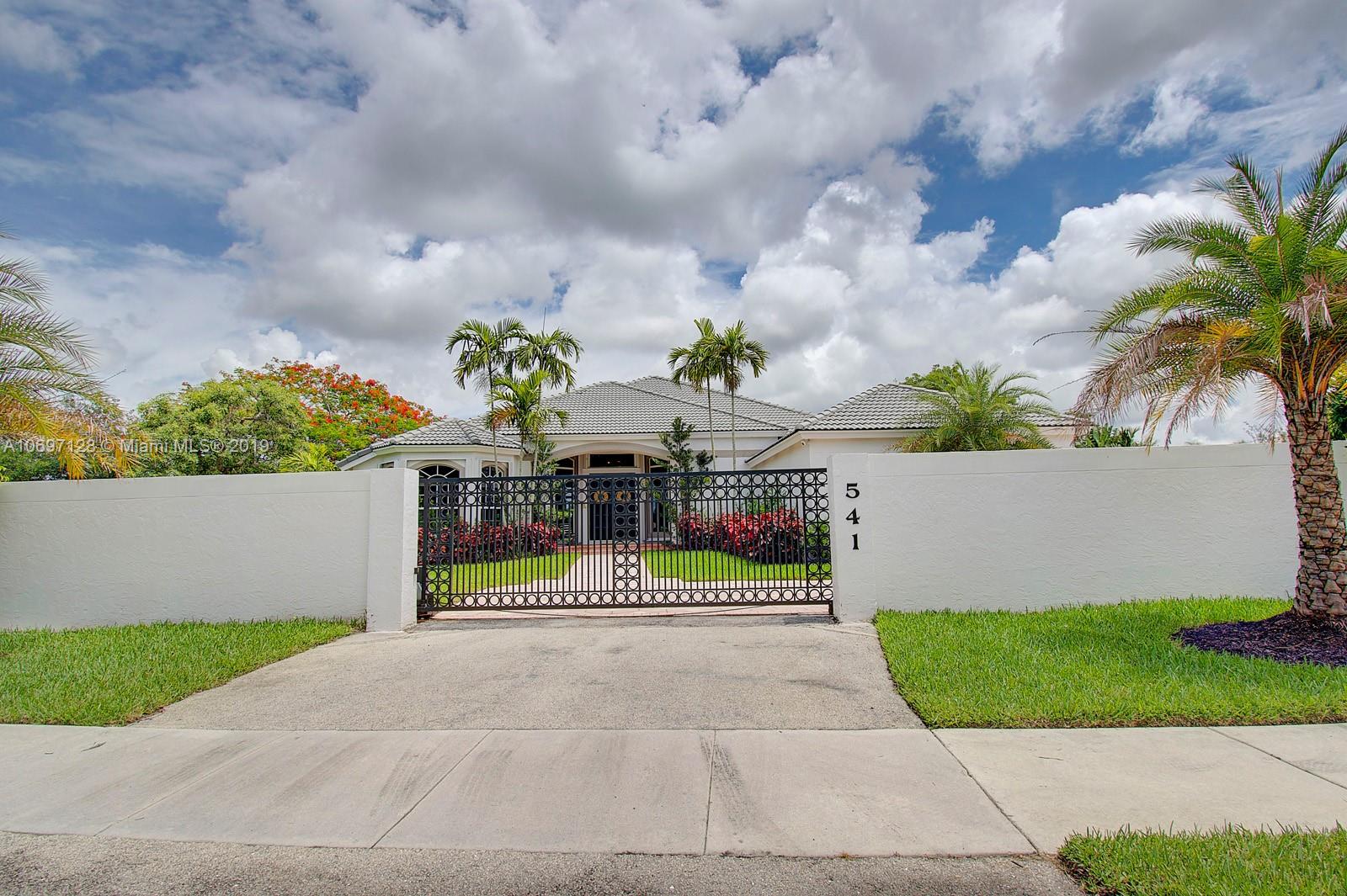 a view of a house with a garden and pathway