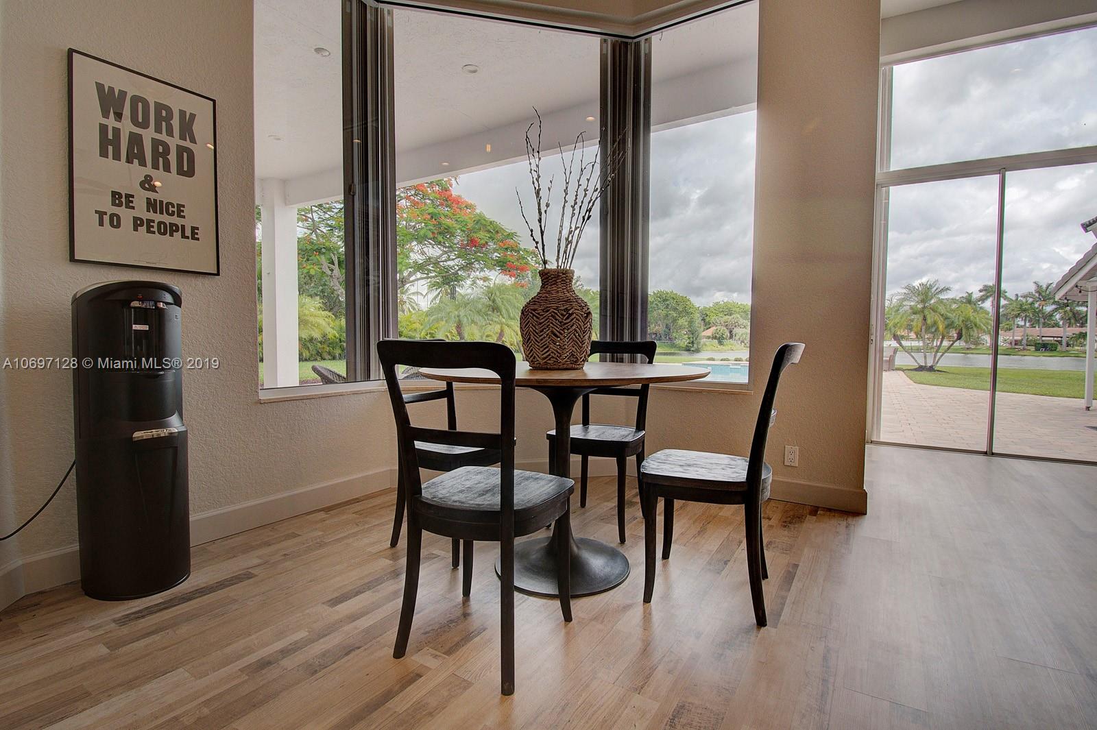 541 Ranch Road Weston, FL 33326 - Photo 12 of 41 a view of a dining room with furniture and wooden floor