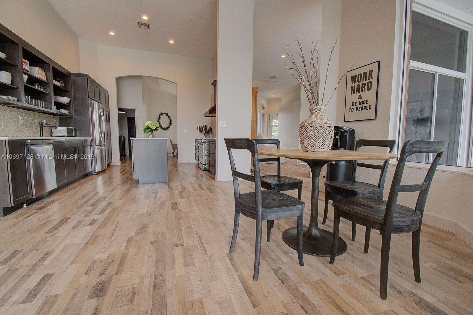541 Ranch Road Weston, FL 33326 - Photo 13 of 41 a view of a dining room with furniture and wooden floor