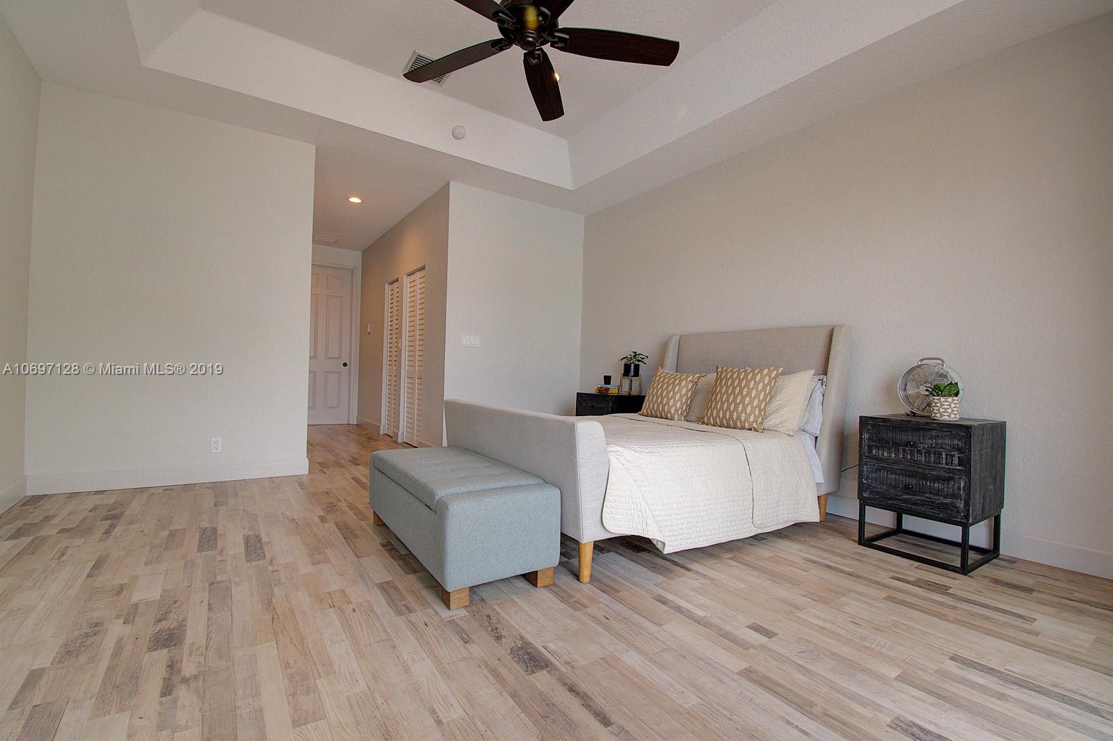 541 Ranch Road Weston, FL 33326 - Photo 17 of 41 a spacious bedroom with a bed and dresser