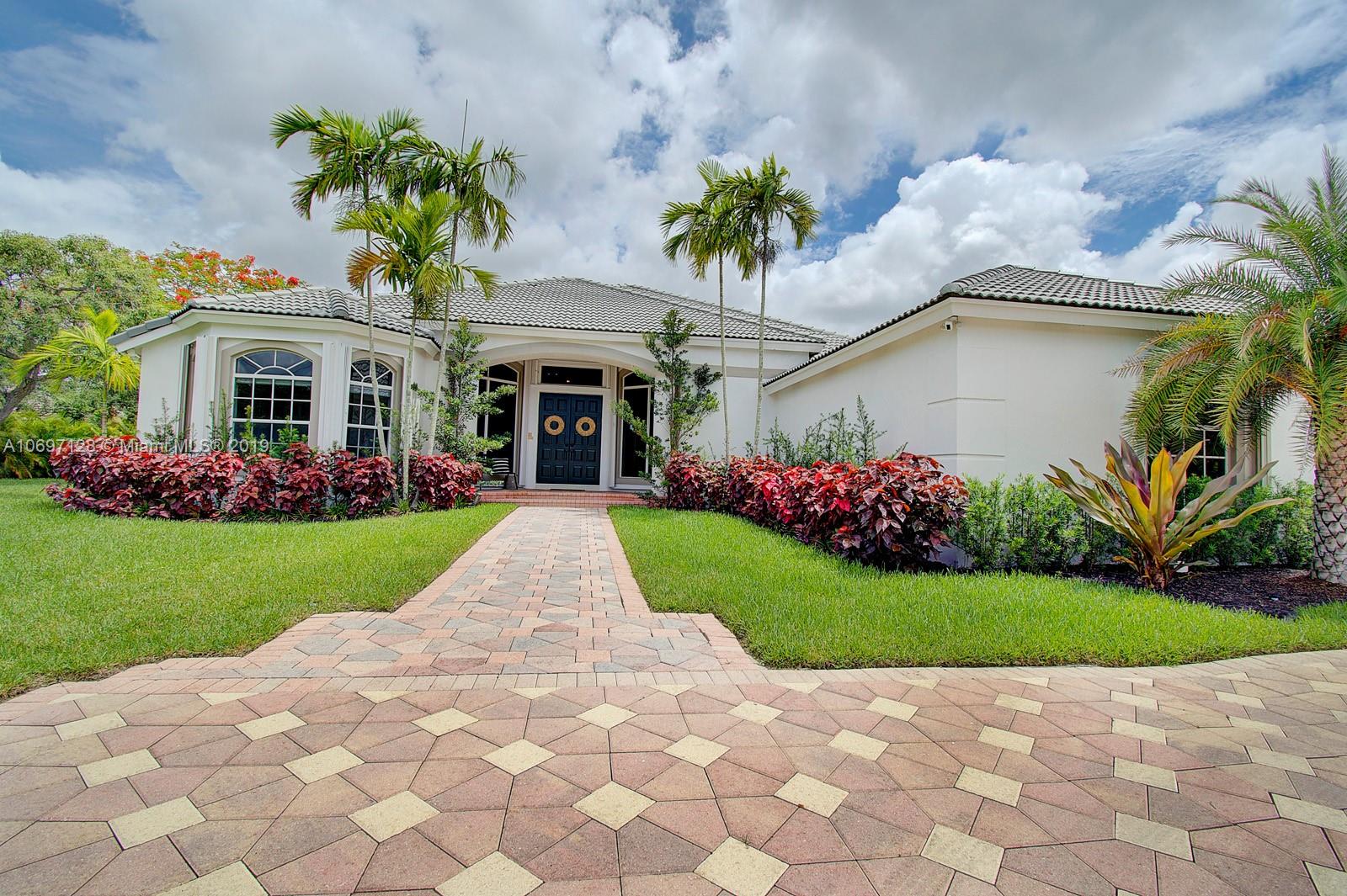 541 Ranch Road Weston, FL 33326 - Photo 2 of 41 a view of an house with backyard and a garden