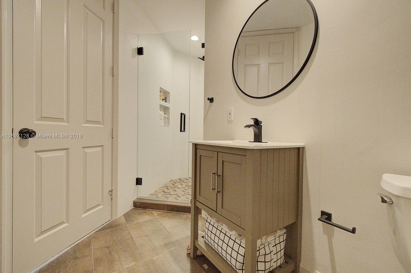 541 Ranch Road Weston, FL 33326 - Photo 21 of 41 a bathroom with a sink and a mirror