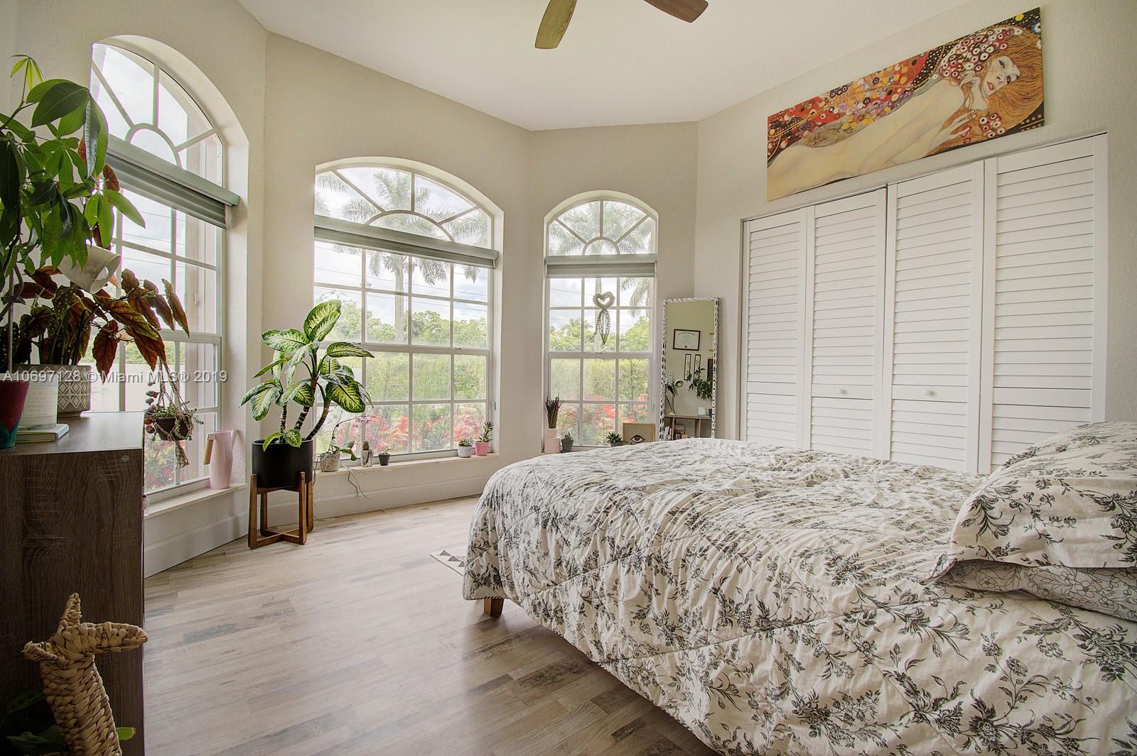 541 Ranch Road Weston, FL 33326 - Photo 22 of 41 a bedroom with a large bed and a large window