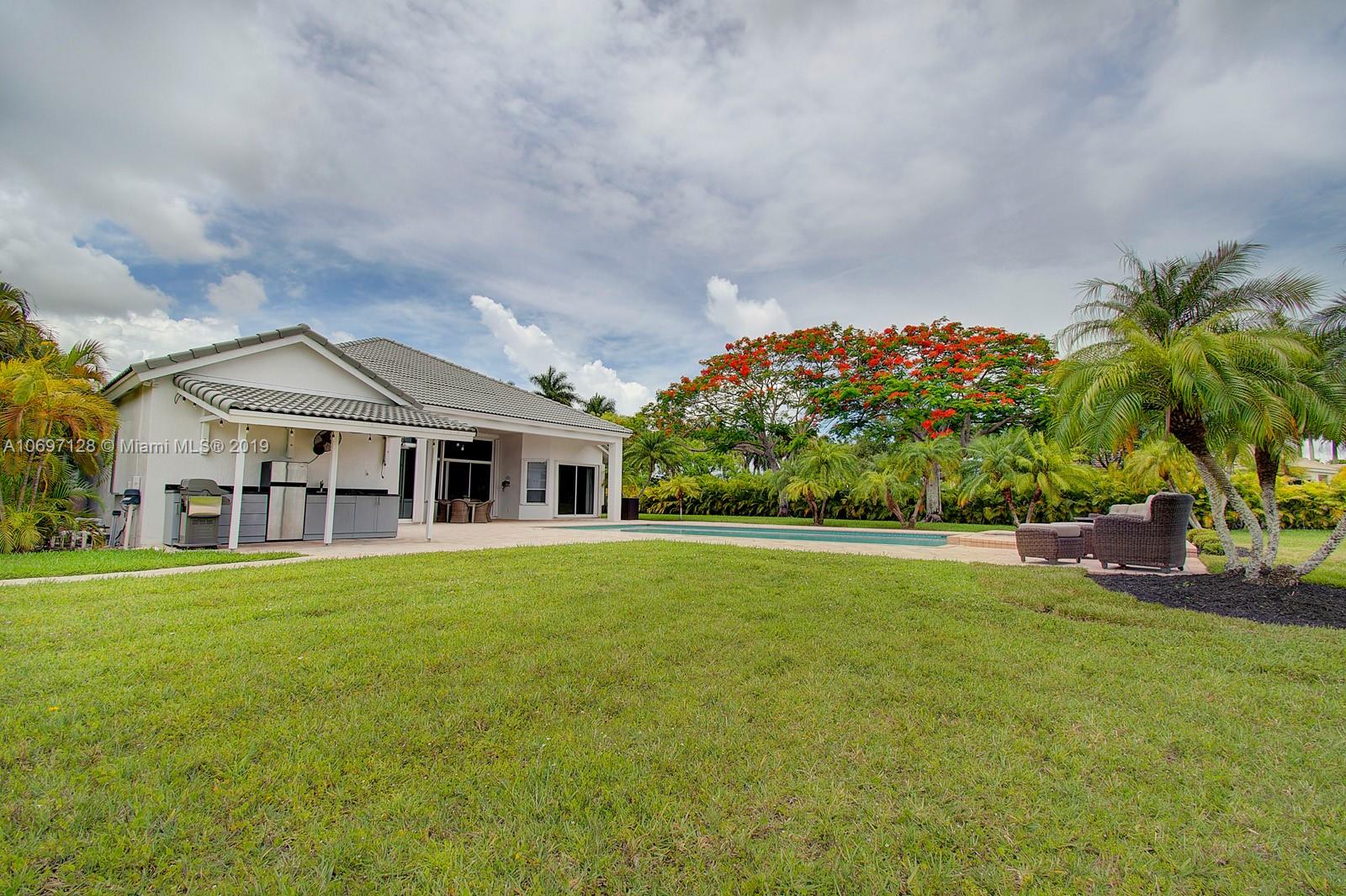 541 Ranch Road Weston, FL 33326 - Photo 29 of 41 a front view of a house with a garden