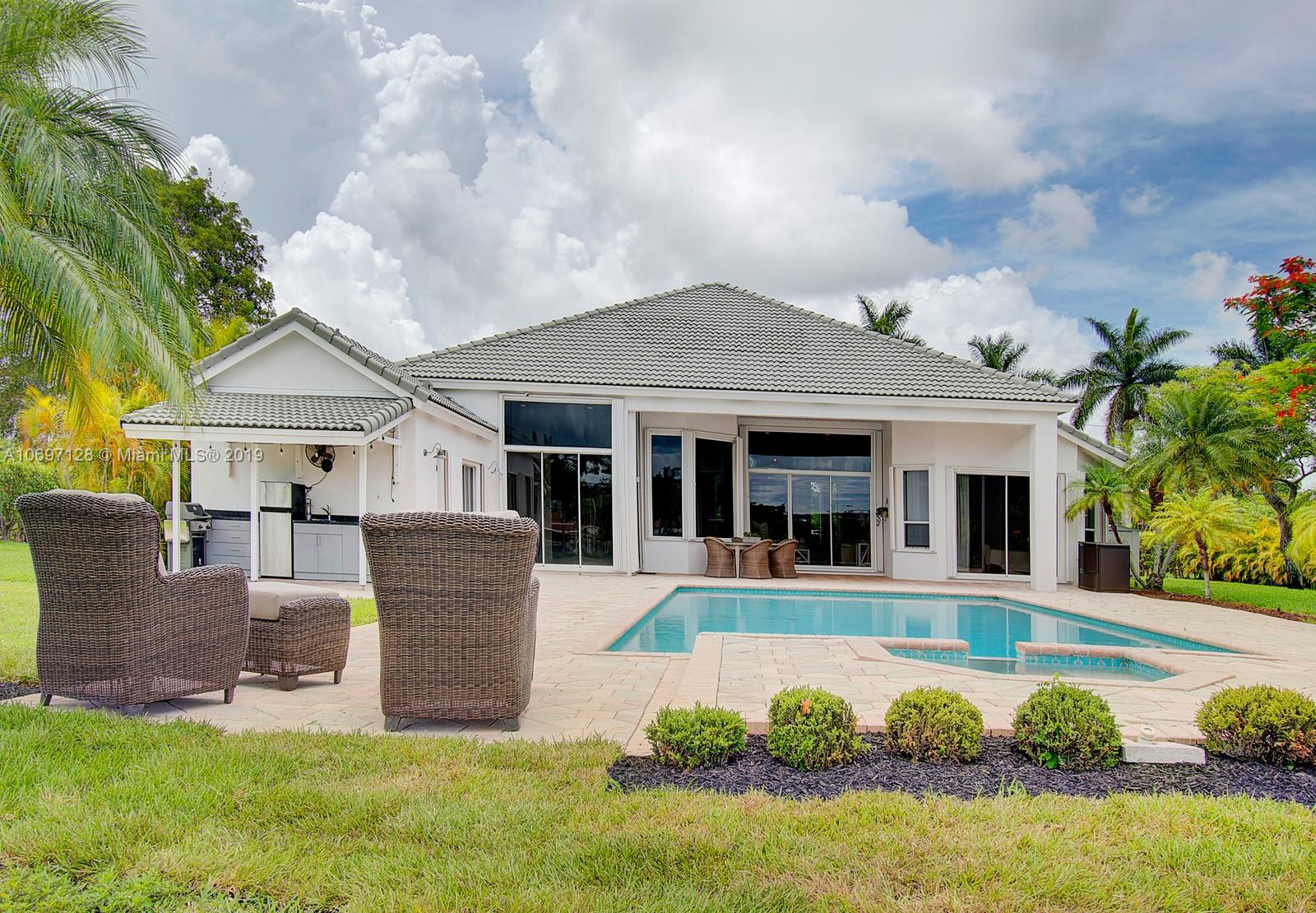 541 Ranch Road Weston, FL 33326 - Photo 31 of 41 a front view of a house with garden