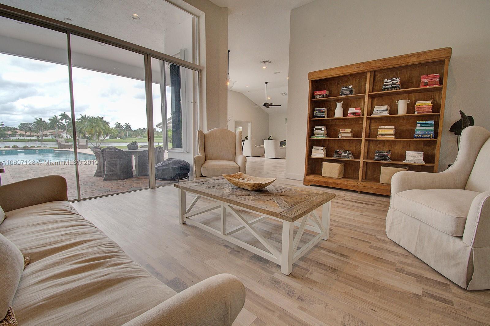 541 Ranch Road Weston, FL 33326 - Photo 5 of 41 a living room with furniture a rug and a large window