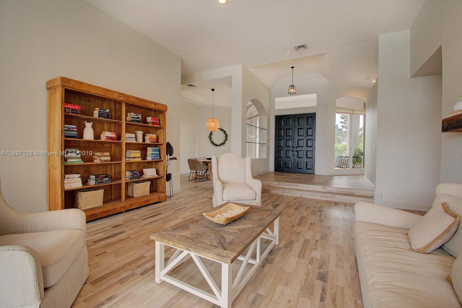 541 Ranch Road Weston, FL 33326 - Photo 6 of 41 a living room with furniture cabinets and window
