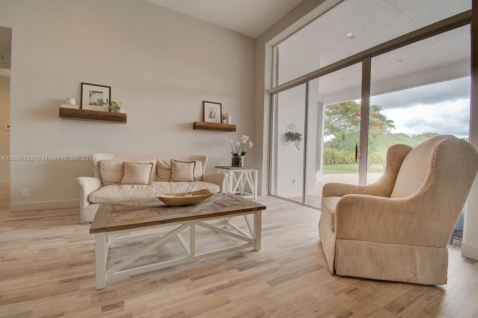 541 Ranch Road Weston, FL 33326 - Photo 7 of 41 a living room with furniture and large windows