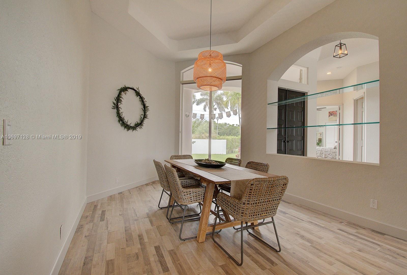 541 Ranch Road Weston, FL 33326 - Photo 8 of 41 a view of a dining room with furniture window and wooden floor