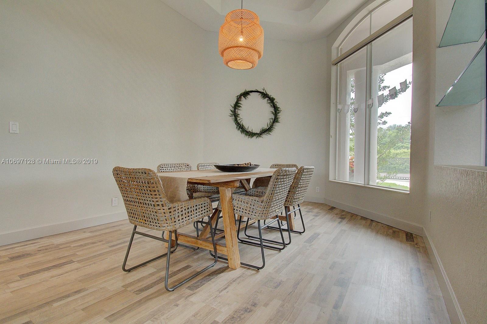541 Ranch Road Weston, FL 33326 - Photo 9 of 41 a view of a dining room with furniture window and wooden floor