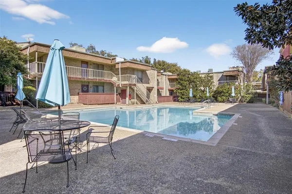 a view of a swimming pool with a lounge chairs